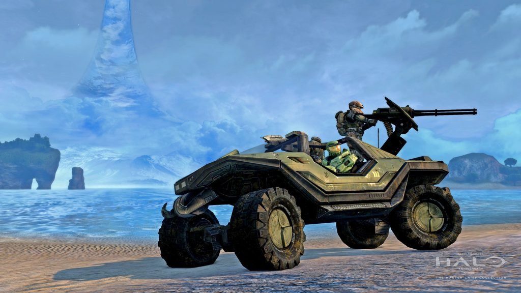 Master Chief driving a Warthog along a beach beneath the Halo ring, with marines aboard