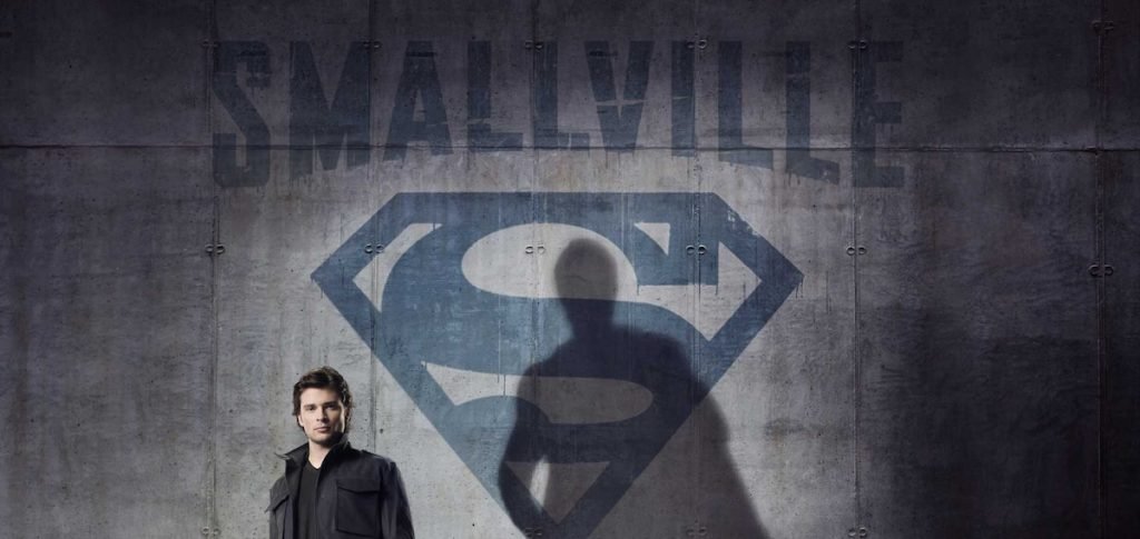 Tom Welling as Clark Kent beneath a Superman-shaped shadow in official Smallville artwork