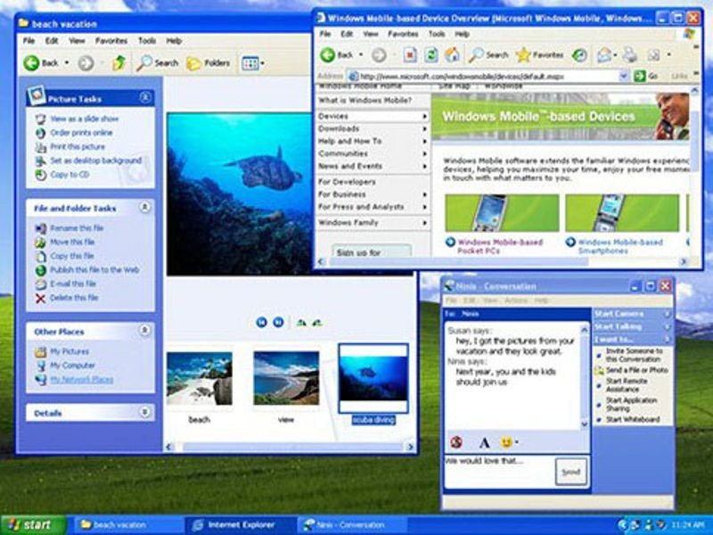 Historical Windows XP desktop showing its blue Luna windows, Internet Explorer and Messenger